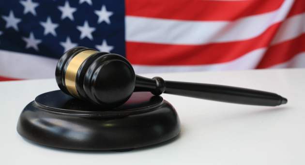 A gavel with the American flag in the background