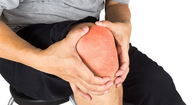 A person holding their knee in pain